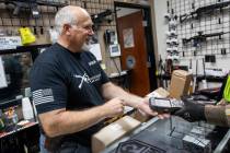 Mark Hames receives a shipment of more gun products at 2nd Amendment Gun Shop on Tuesday, March ...