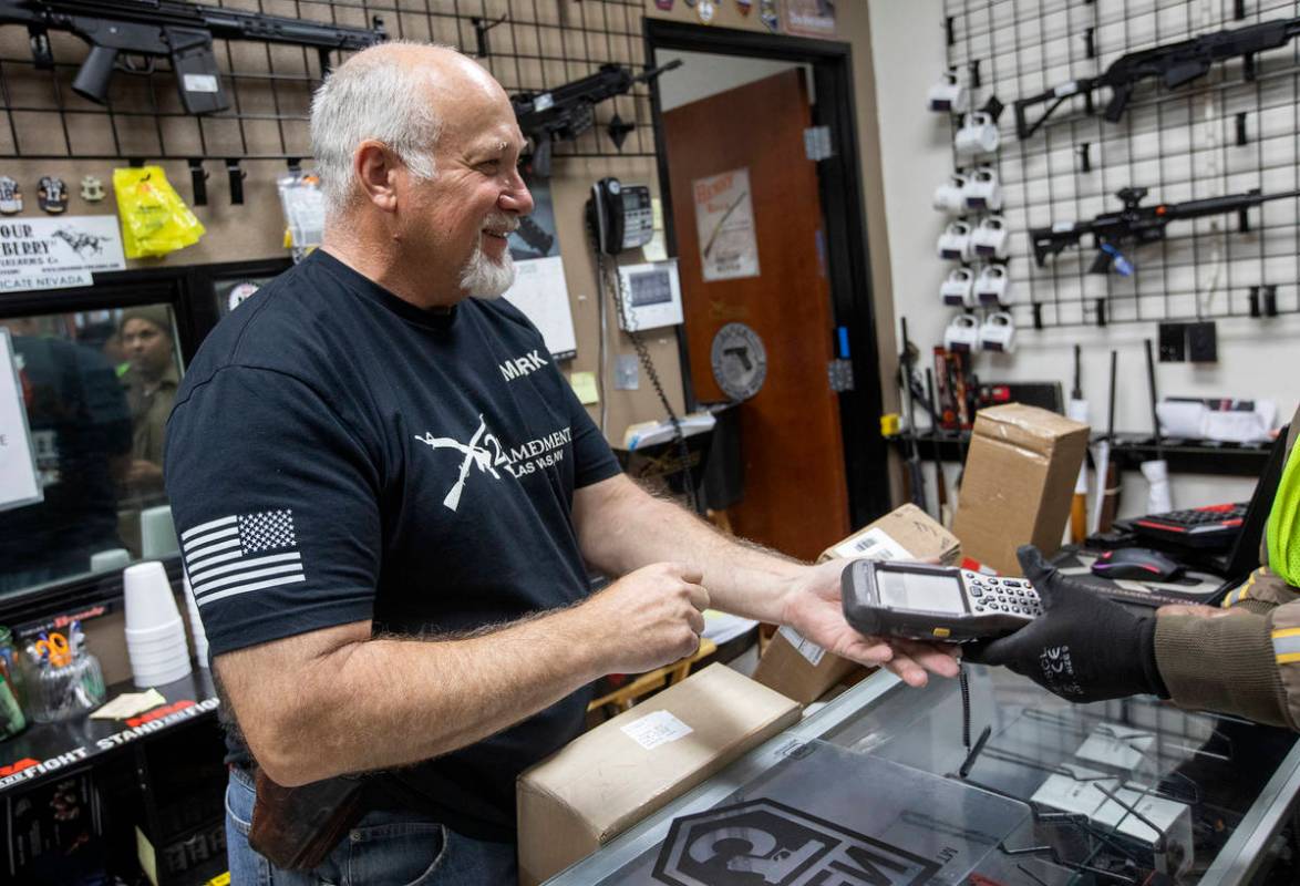 Mark Hames receives a shipment of more gun products at 2nd Amendment Gun Shop on Tuesday, March ...