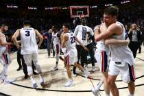Gonzaga players celebrate after defeating St. Mary's to win the West Coast Conference tournamen ...