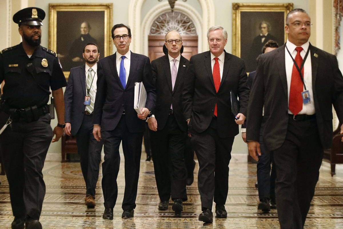 Treasury Secretary Steven Mnuchin, left, accompanied by White House Legislative Affairs Directo ...