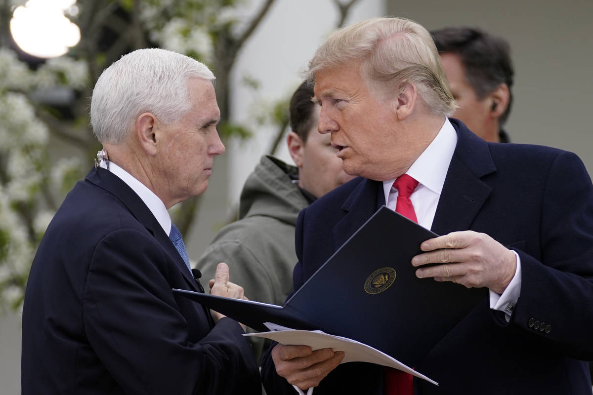 President Donald Trump speaks with Vice President Mike Pence as they arrive for a Fox News Chan ...