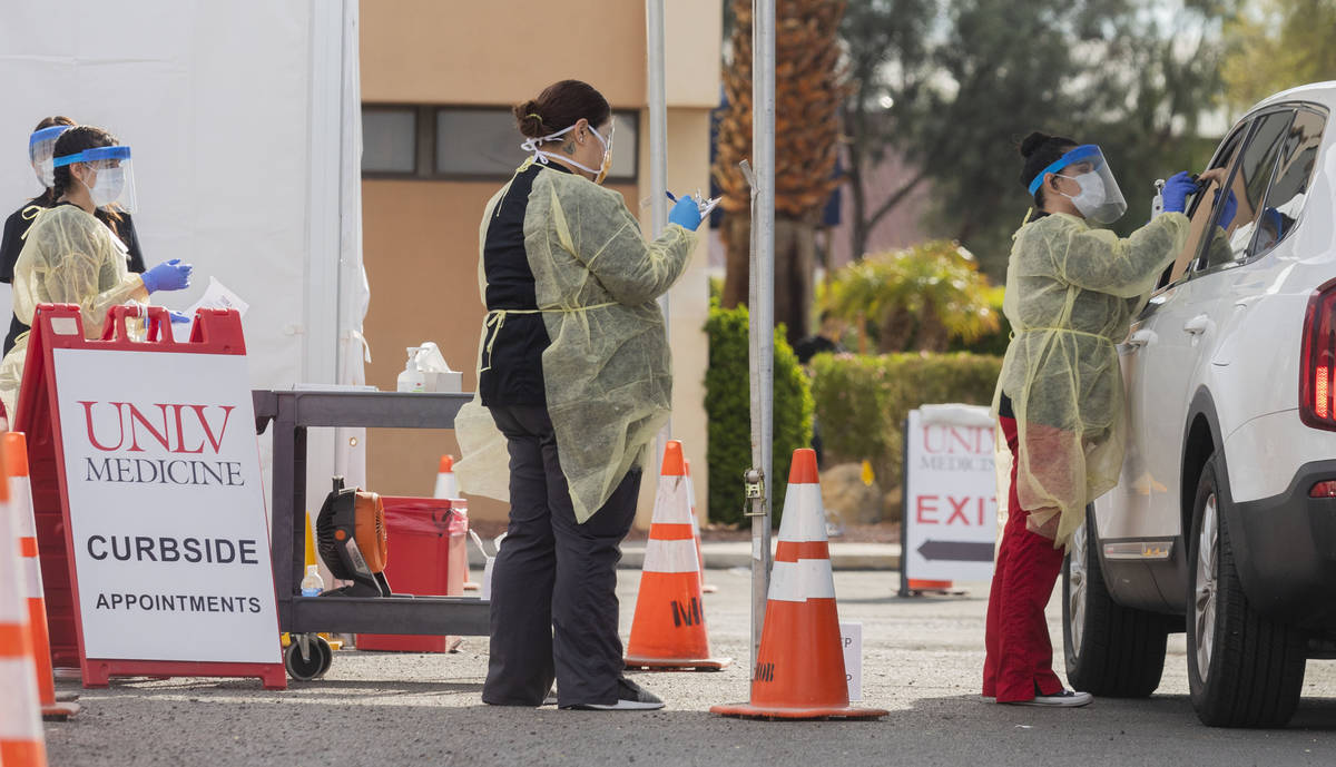UNLV medicine medical professionals conduct a curbside test on a patient experiencing coronavir ...
