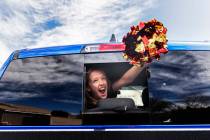 Ella Sproule, 11, waves from her mothers truck during a parade organized by O’Roarke Ele ...