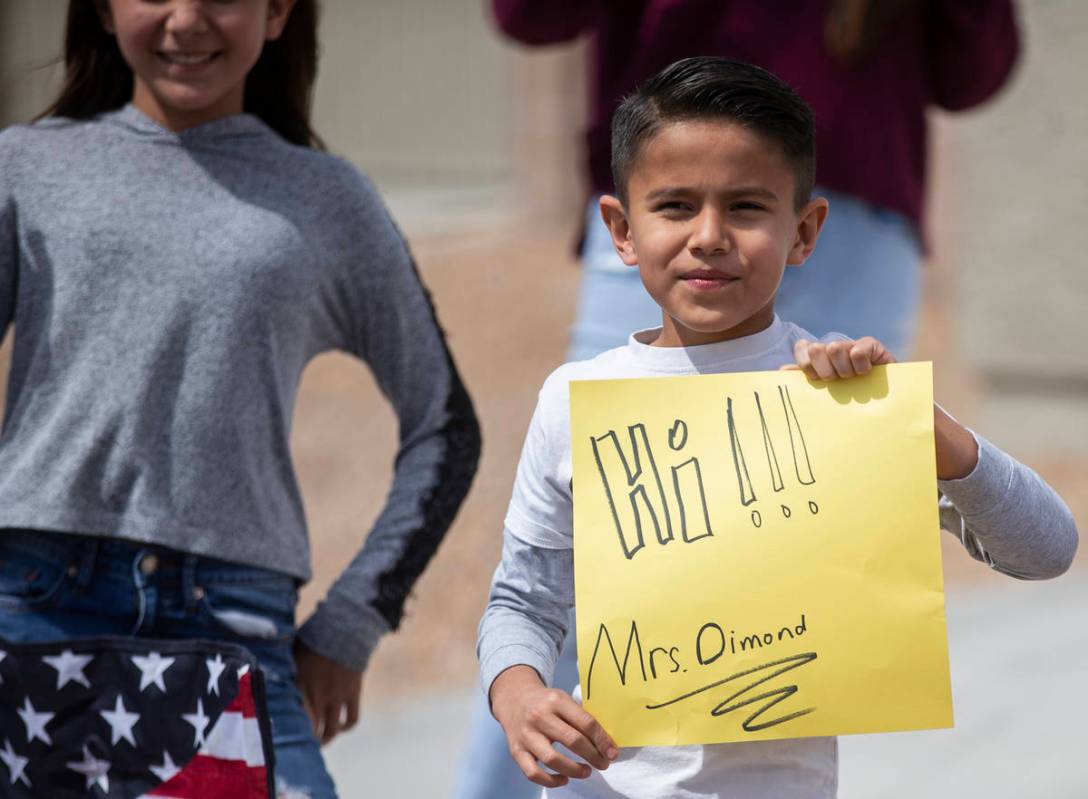 Las Vegas residents wave to teachers and staff from O’Roarke Elementary School who organ ...