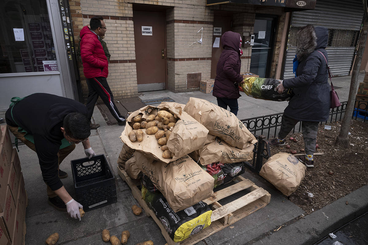 A Manager At Masbia Soup Kitchen Picks Up Spilled Potatoes That Are Being Distributed During Th Las Vegas Review Journal