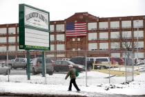 FILE - In this Jan. 17, 2013, file photo, a man walks past the Remington Arms Company in Ilion, ...