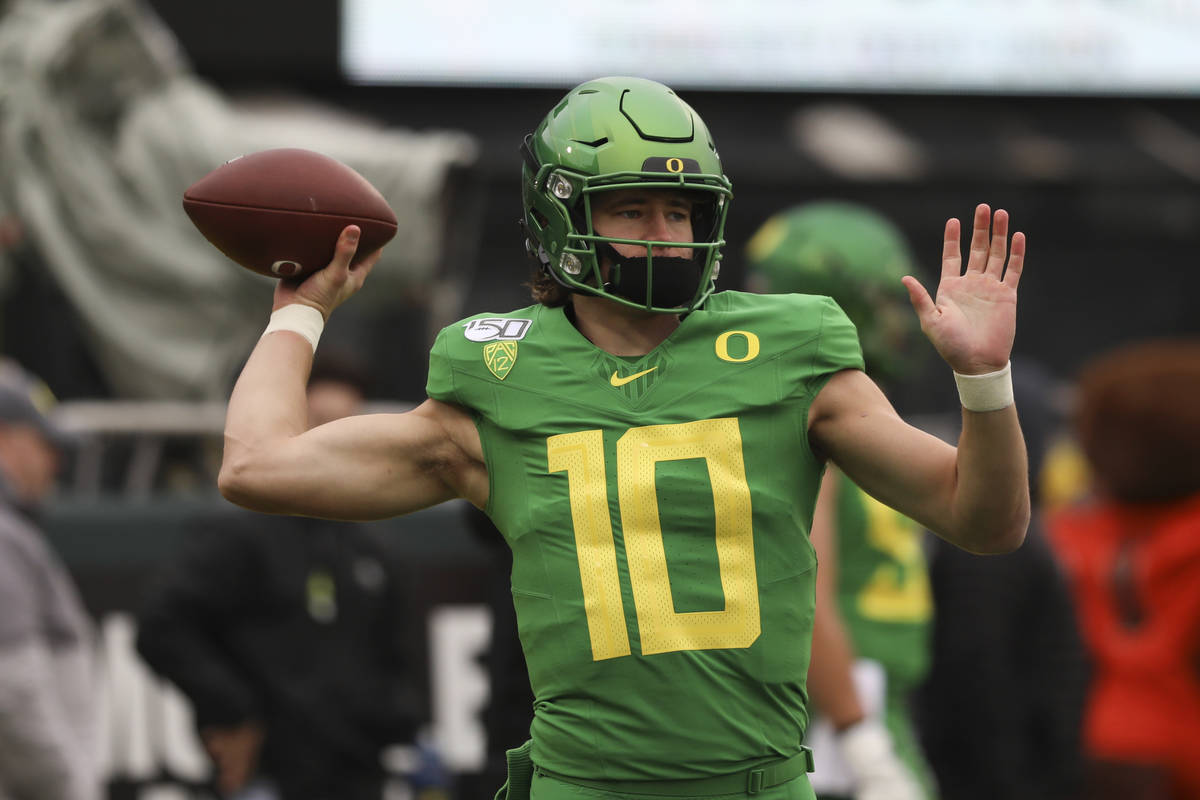Oregon quarterback Justin Herbert (10) warms up prior to the start of an NCAA college football ...
