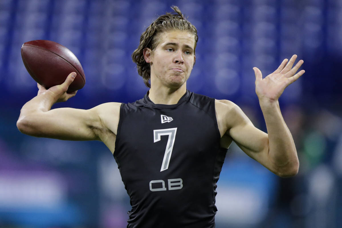 Oregon quarterback Justin Herbert runs a drill at the NFL football scouting combine in Indianap ...