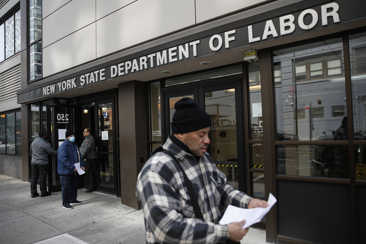 In a March 18, 2020, file photo, visitors to the Department of Labor are turned away at the doo ...