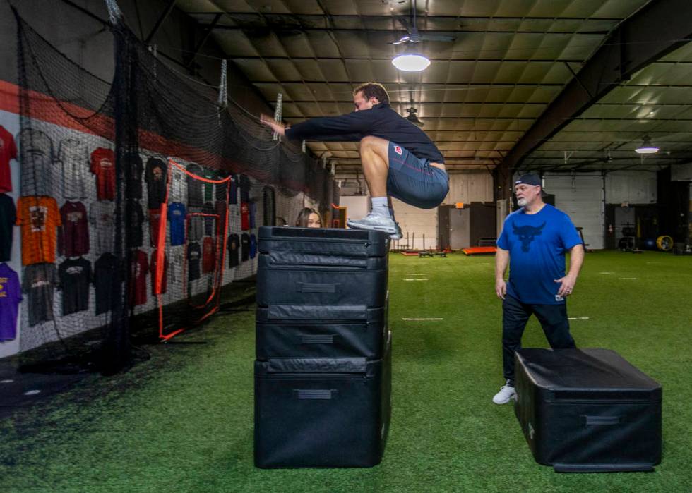Las Vegas Raiders fullback Alec Ingold, left, vertically leaps high onto stacked pads while tra ...