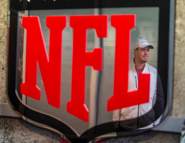 Las Vegas Raiders fullback Alec Ingold is reflected in an NFL plaque as he stops off for a visi ...