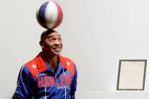 FILE - In this Dec. 10, 2010, file photo, Harlem Globetrotters Fred "Curly" Neal spin ...