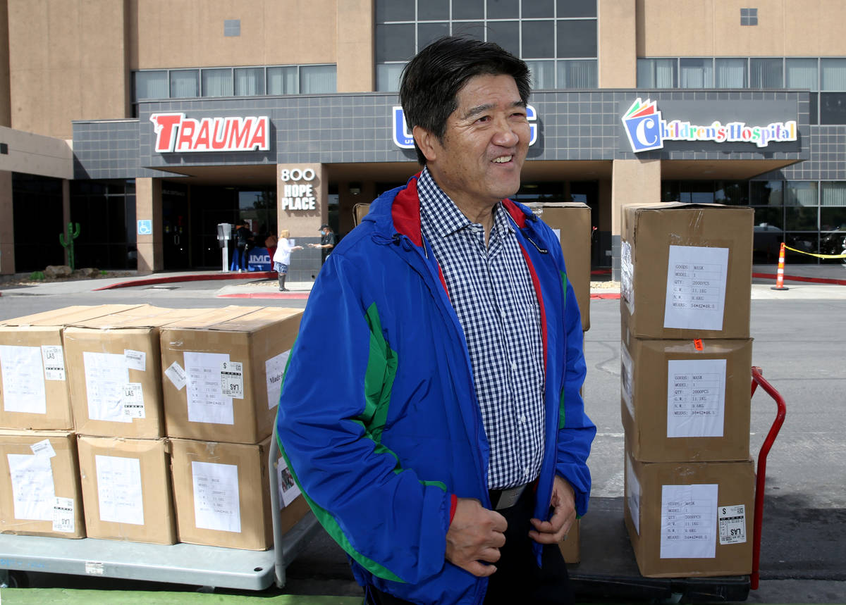 Jiaming Zhang, secretary of the Nevada Chinese Association, with 33,000 surgical masks and 500 ...