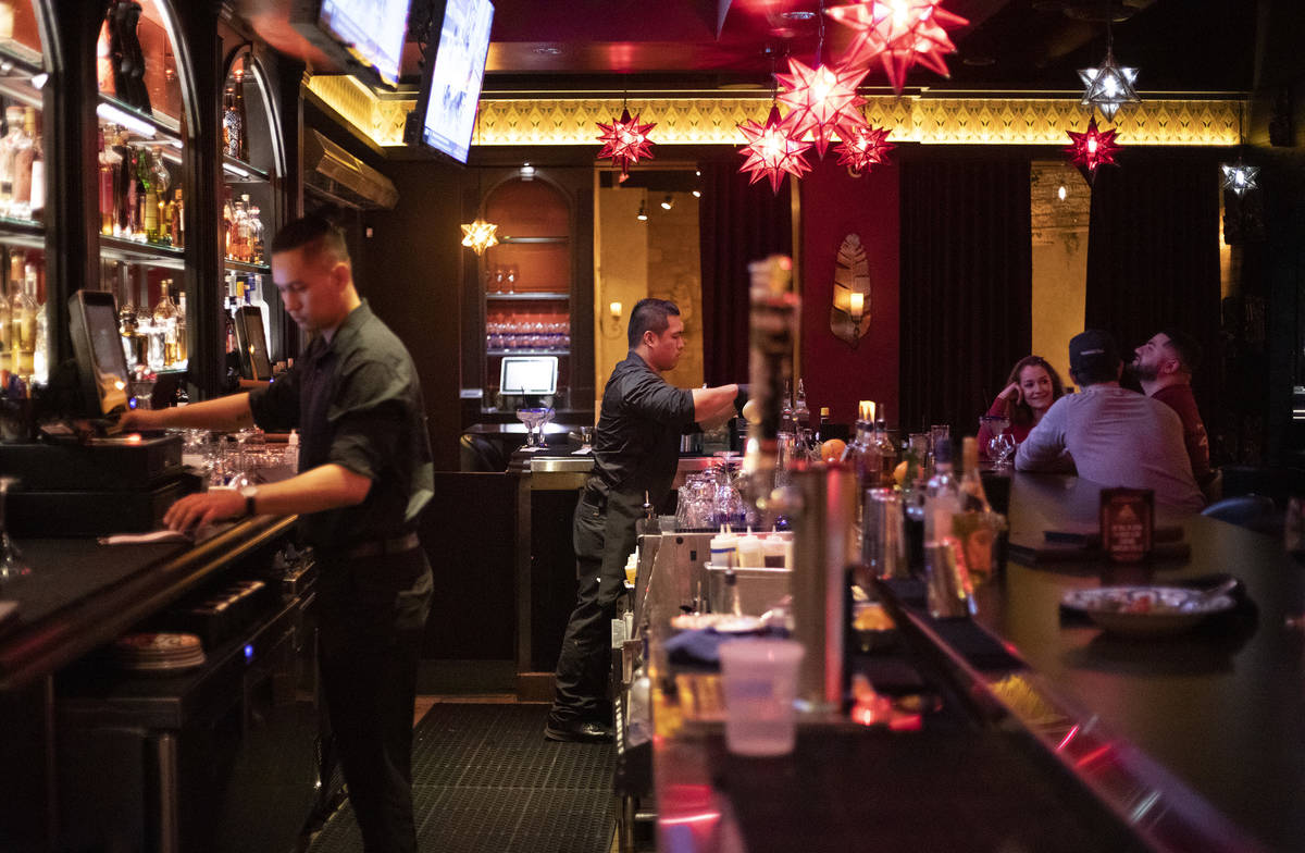 Christian Carino, center, mixes drinks at El Dorado Cantina in Tivoli Village on Tuesday, March ...