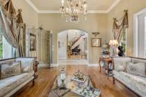 A parlor off the entry features hand-scraped cherry hardwood flooring. (Red Luxury Real Estate)