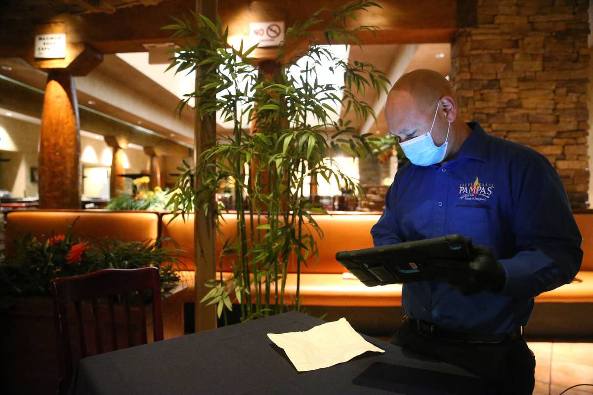 Lawrence D., floor manager of Pampas Las Vegas, processes an order at the restaurant in the Mir ...