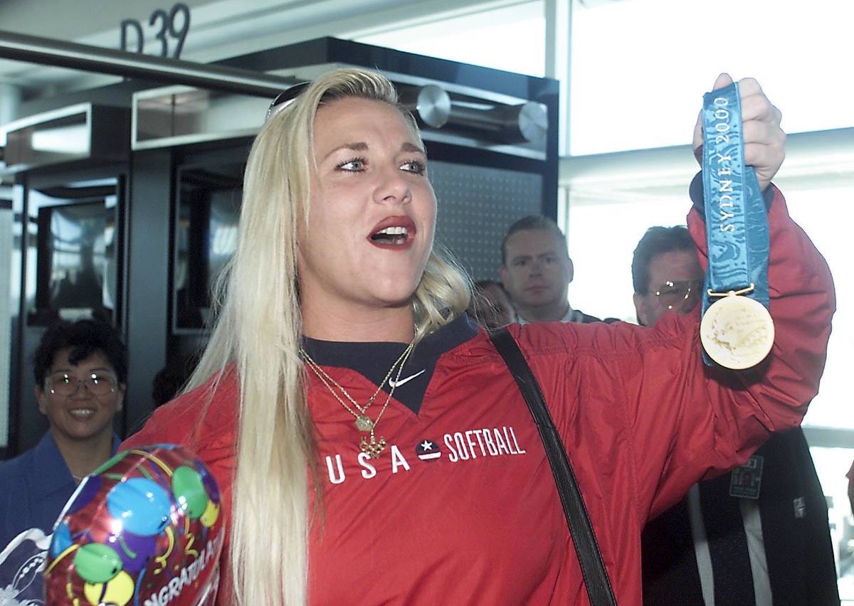 Former UNLV star softball pitcher Lori Harrigan shows off her gold medal from the Olympics. (La ...