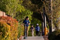 Children ride their scooters on North Hualapai Way on Friday, March 27, 2020, in Las Vegas. (Be ...
