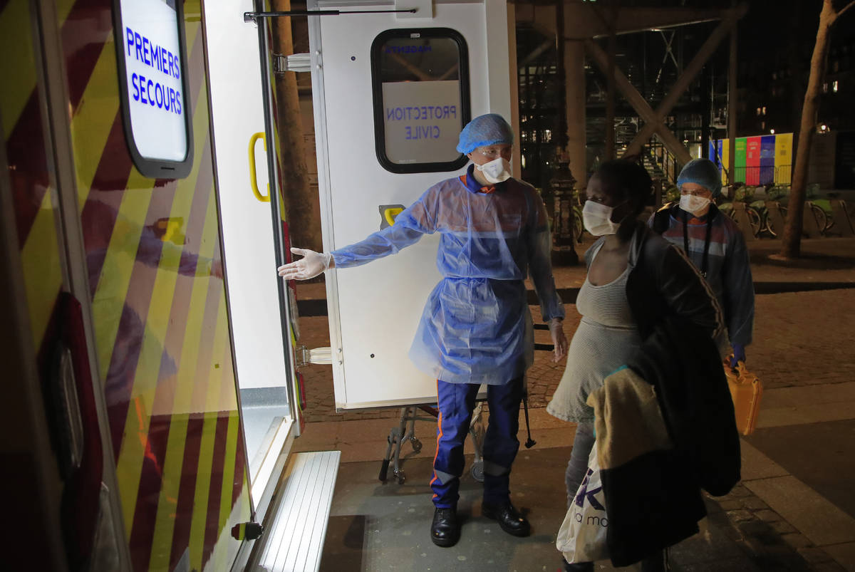 Members of the Protection Civile with protective mask Vincent Jactel, left, and Aurore Lejeune, ...