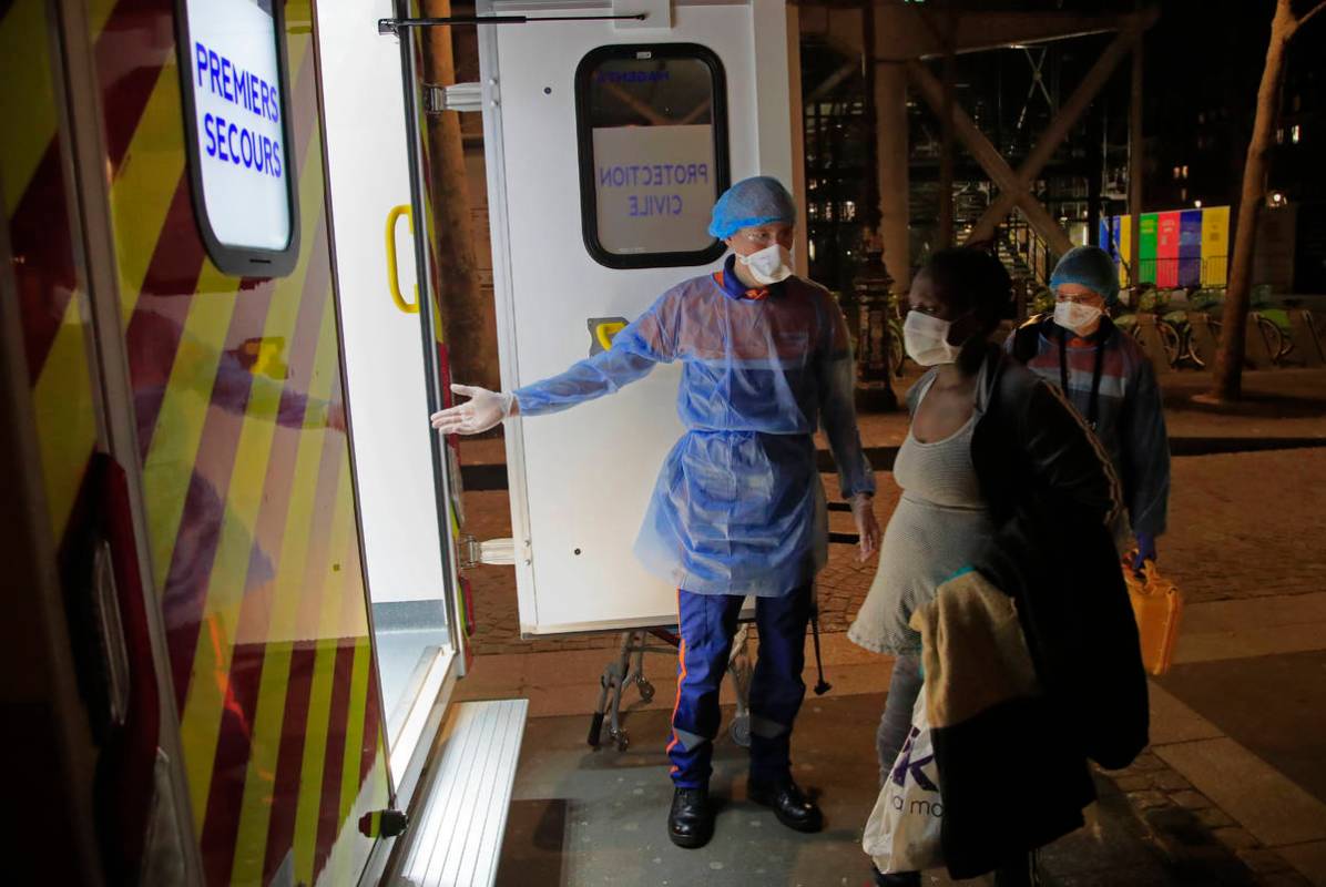 Members of the Protection Civile with protective mask Vincent Jactel, left, and Aurore Lejeune, ...