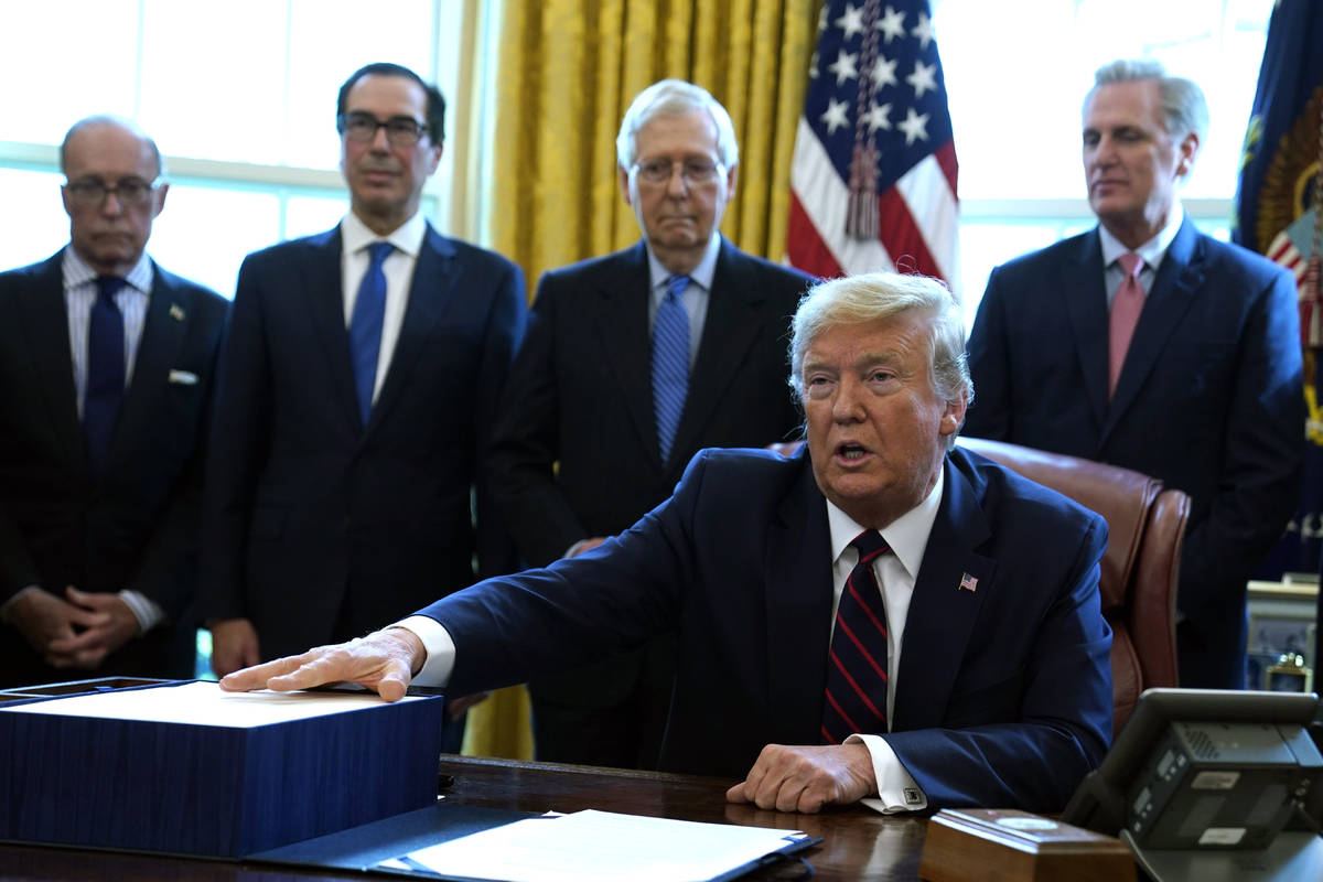 President Donald Trump speaks before he signs the coronavirus stimulus relief package in the Ov ...