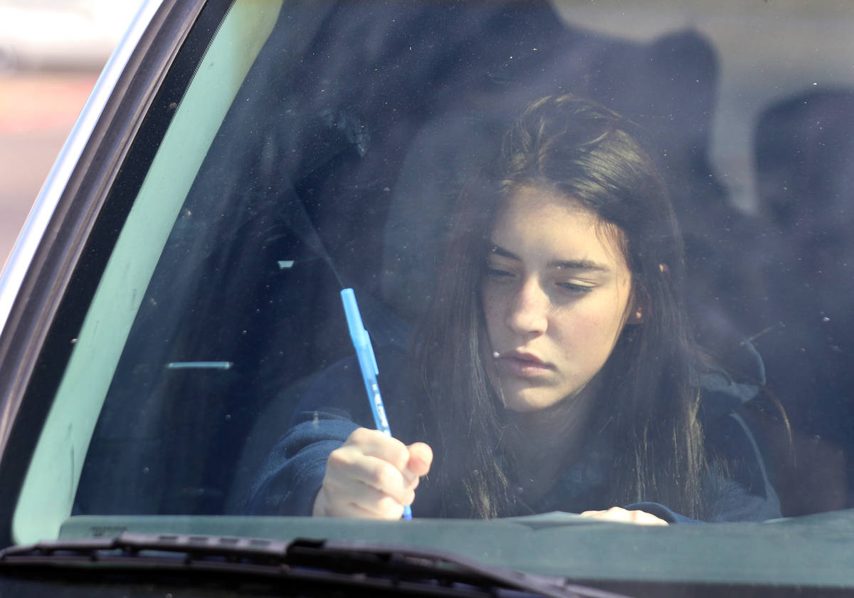 Samantha Martin, senior at Spring Valley High School, fills out forms prior to receiving a Chro ...