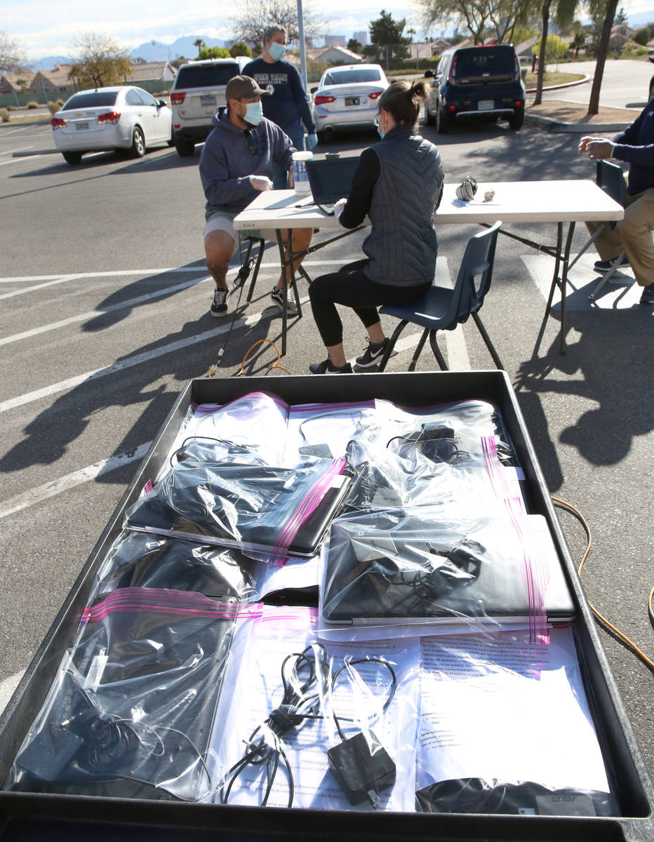 Spring Valley High School staff prepare to hand out Chromebooks to students on Friday, March 27 ...