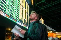 Rufus Peabody, middle, from Boston, Mass., waits in line at Westgate Sportsbook as Super Bowl p ...