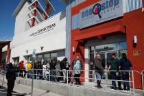 People wait in line at One-Stop Career Center on Monday, March 16, 2020, in Las Vegas. (Bizuaye ...