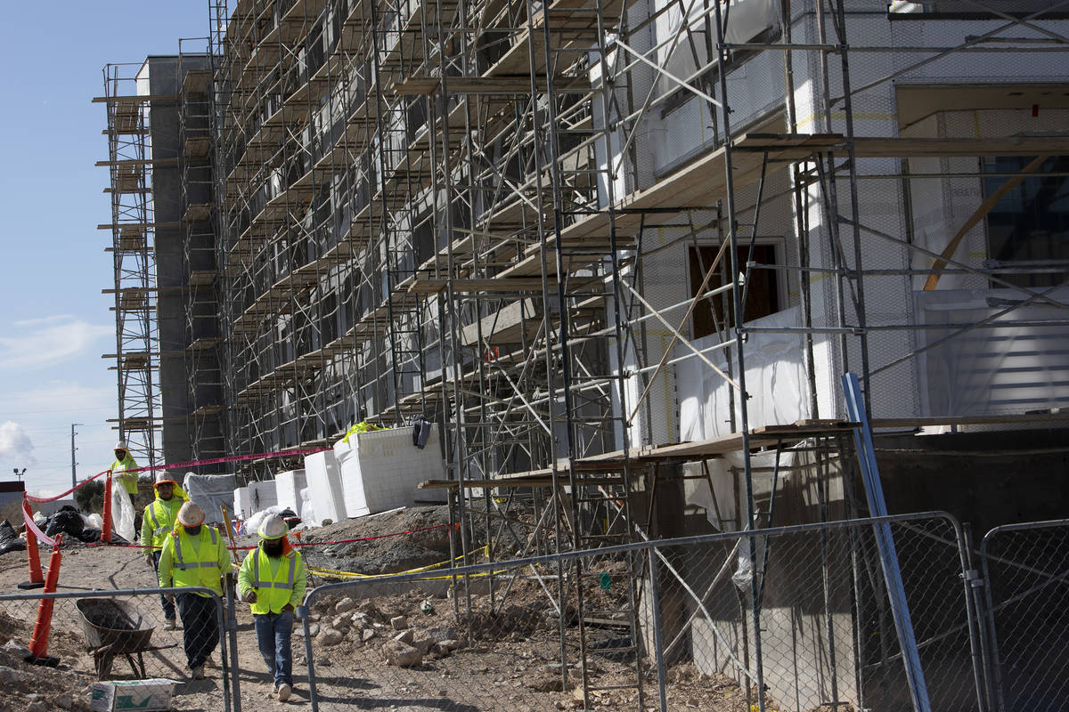 Workers continue construction at a site next to Palms on Friday, March 27, 2020, in Las Vegas. ...