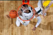 Michigan State's Xavier Tillman pulls in a rebound against Michigan during the first half of an ...
