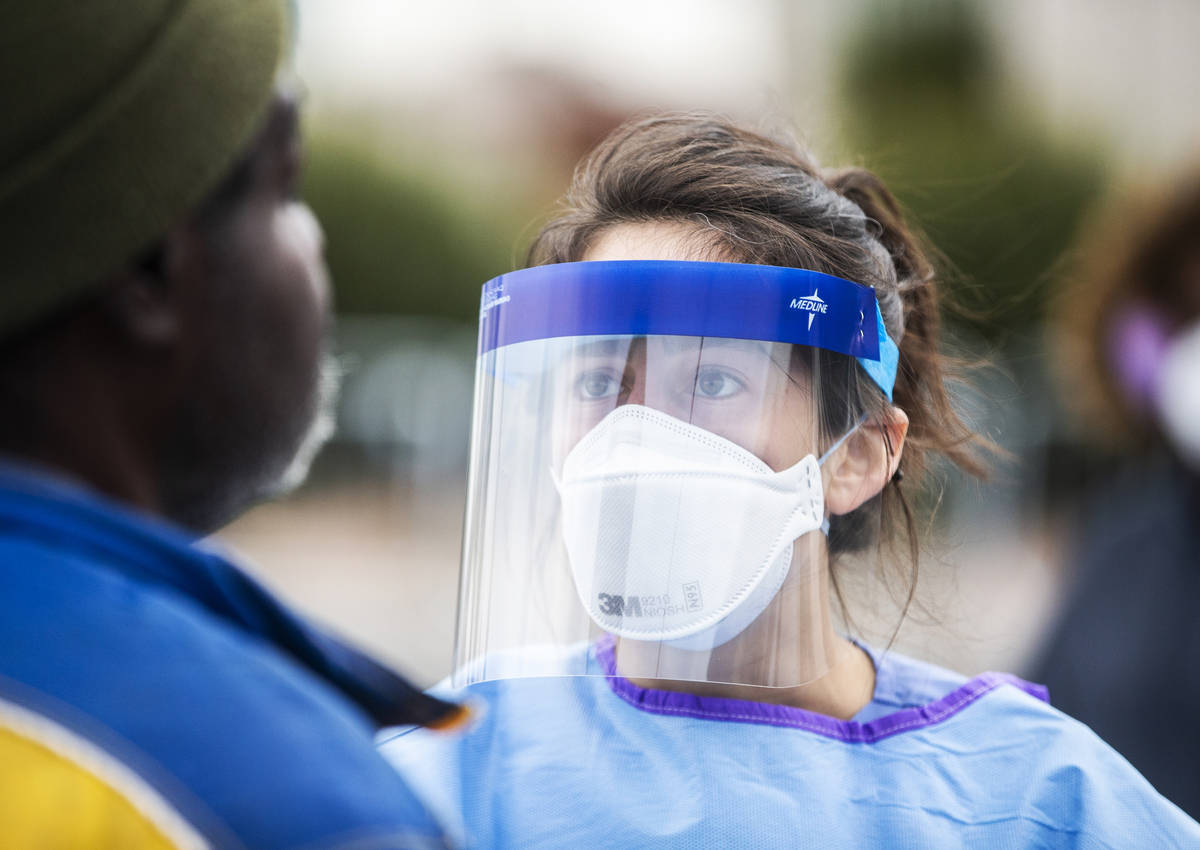 Touro University Nevada medical student Allison Moran screens Micheal Hamilton for signs of the ...