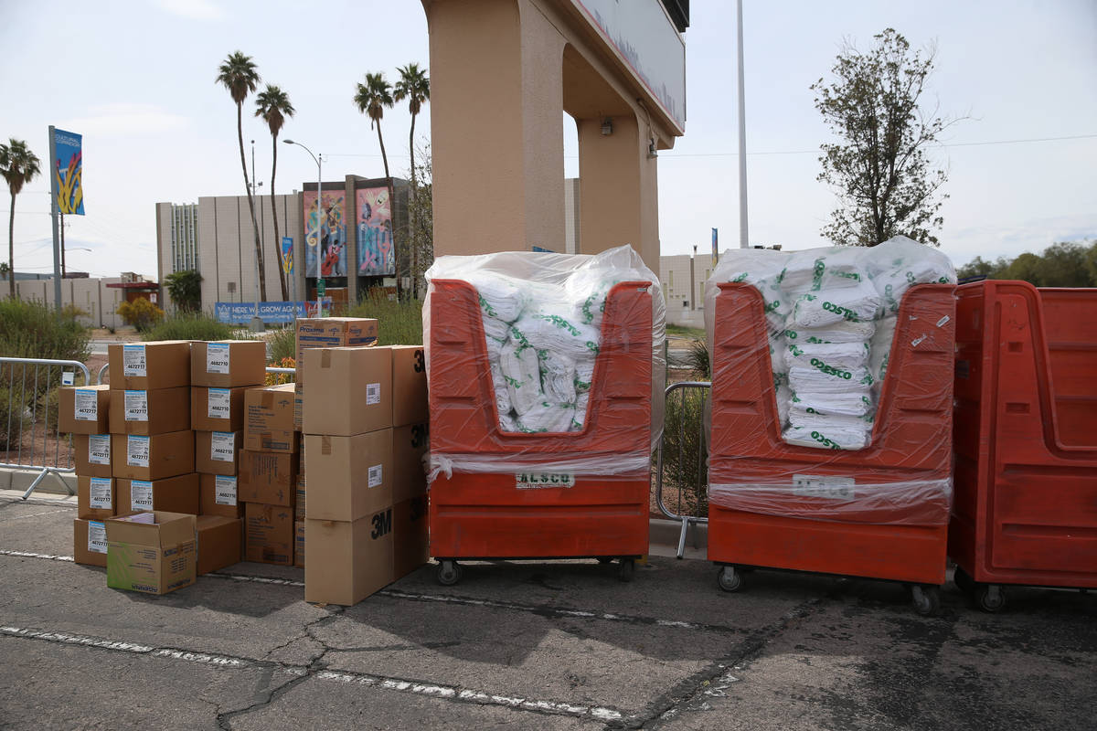 Masks and other supplies are seen at a temporary homeless shelter at the Cashman Field parking ...