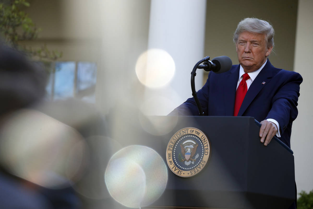 President Donald Trump listens to a question from a reporter as he speaks about the coronavirus ...