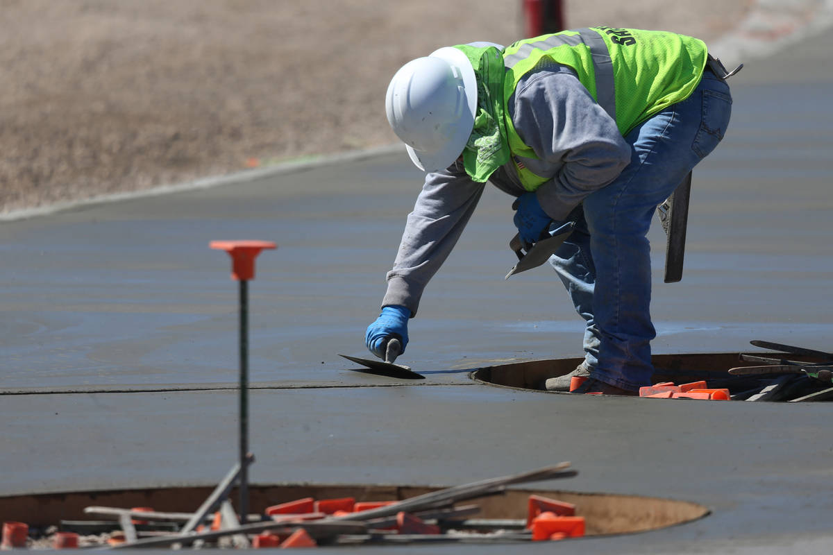 A worker resurfaces concrete at the Raiders Allegiant Stadium in Las Vegas, Tuesday, March 24, ...