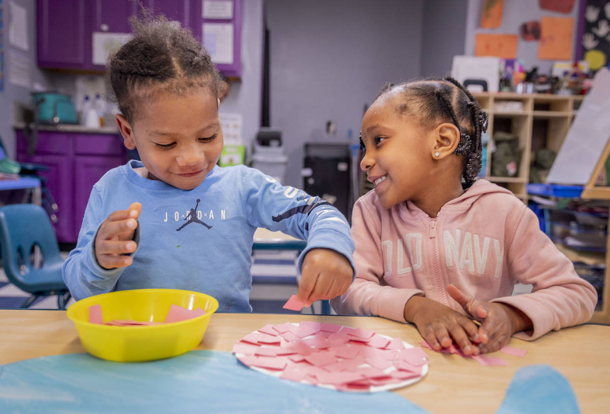 Ka'Mari Wilkerson, 3, left, and Ka'Niyah Wilderson, 5, decorate an Easter Bunny at the Discover ...