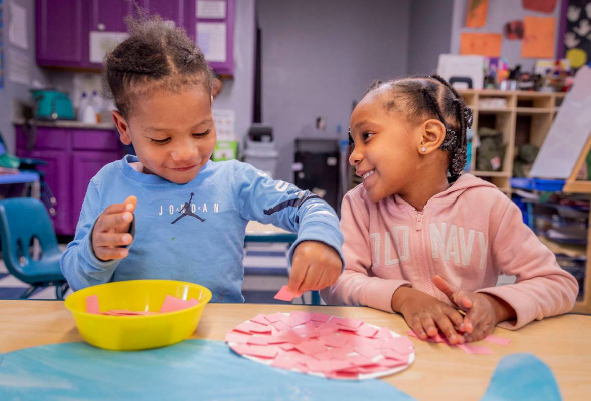 Ka'Mari Wilkerson, 3, left, and Ka'Niyah Wilderson, 5, decorate an Easter Bunny at the Discover ...
