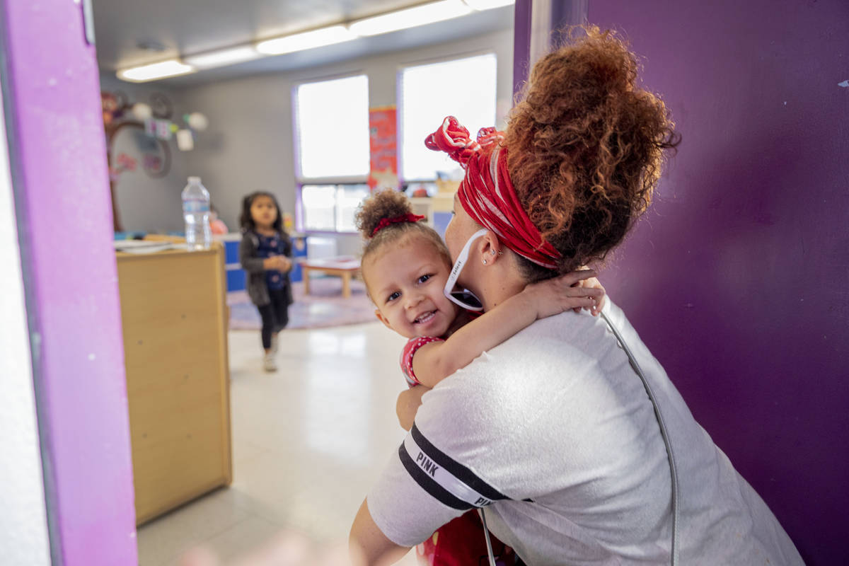 Sarah Washington picks up her daughter Snow Walls, 2, from the Discovery Gardens Childcare Bona ...