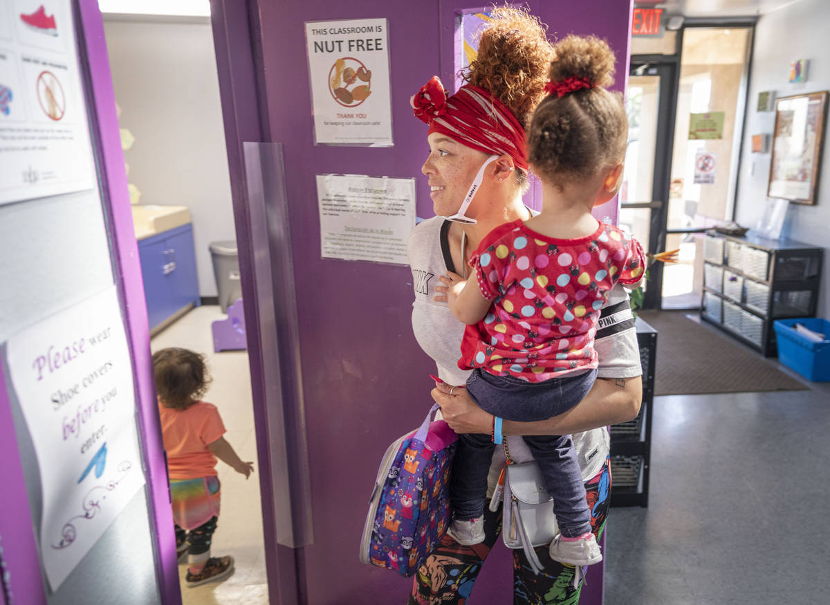 Sarah Washington picks up her daughter Snow Walls, 2, from the Discovery Gardens Childcare Bona ...