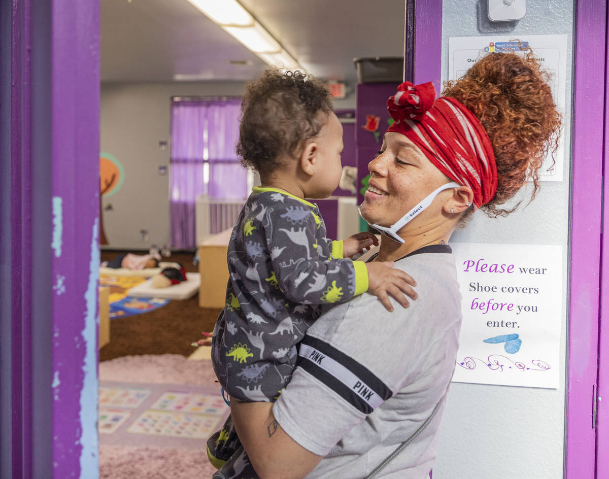 Sarah Washington picks up her son Price Wall, 9 months, from the Discovery Gardens Childcare Bo ...