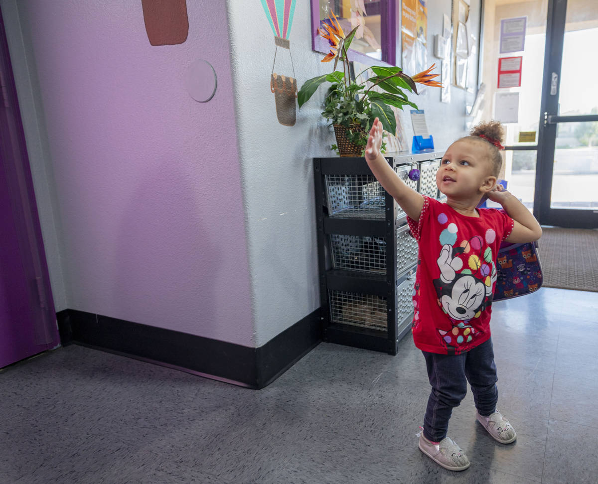 Snow Walls, 2, waves goodbye to her instructor while getting picked up from the Discovery Garde ...