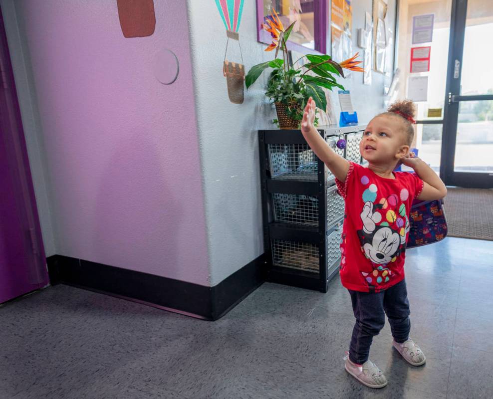 Snow Walls, 2, waves goodbye to her instructor while getting picked up from the Discovery Garde ...