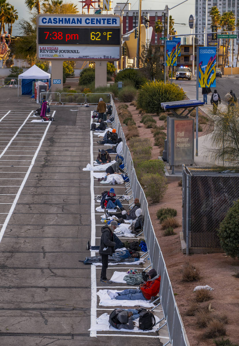 Homeless men settle in for the night with social distancing at the temporary shelter in the upp ...