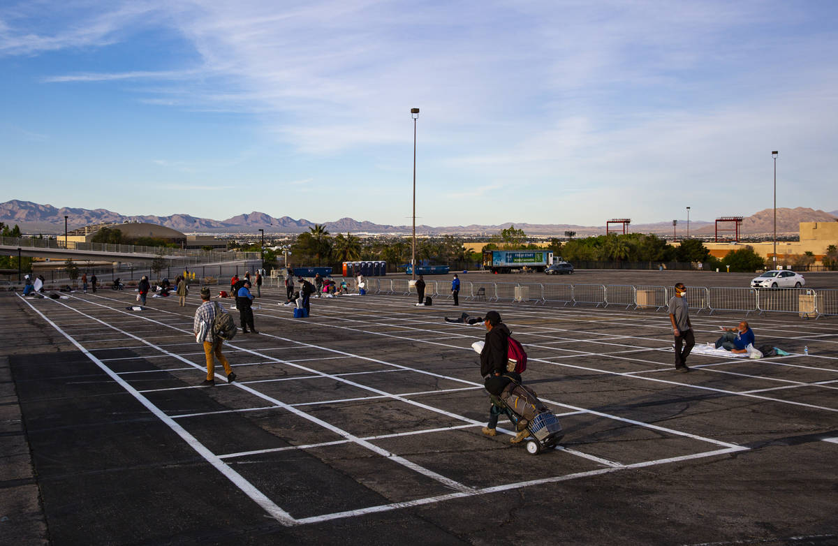Homeless people enter a temporary shelter in the upper parking lot at Cashman Center due to the ...