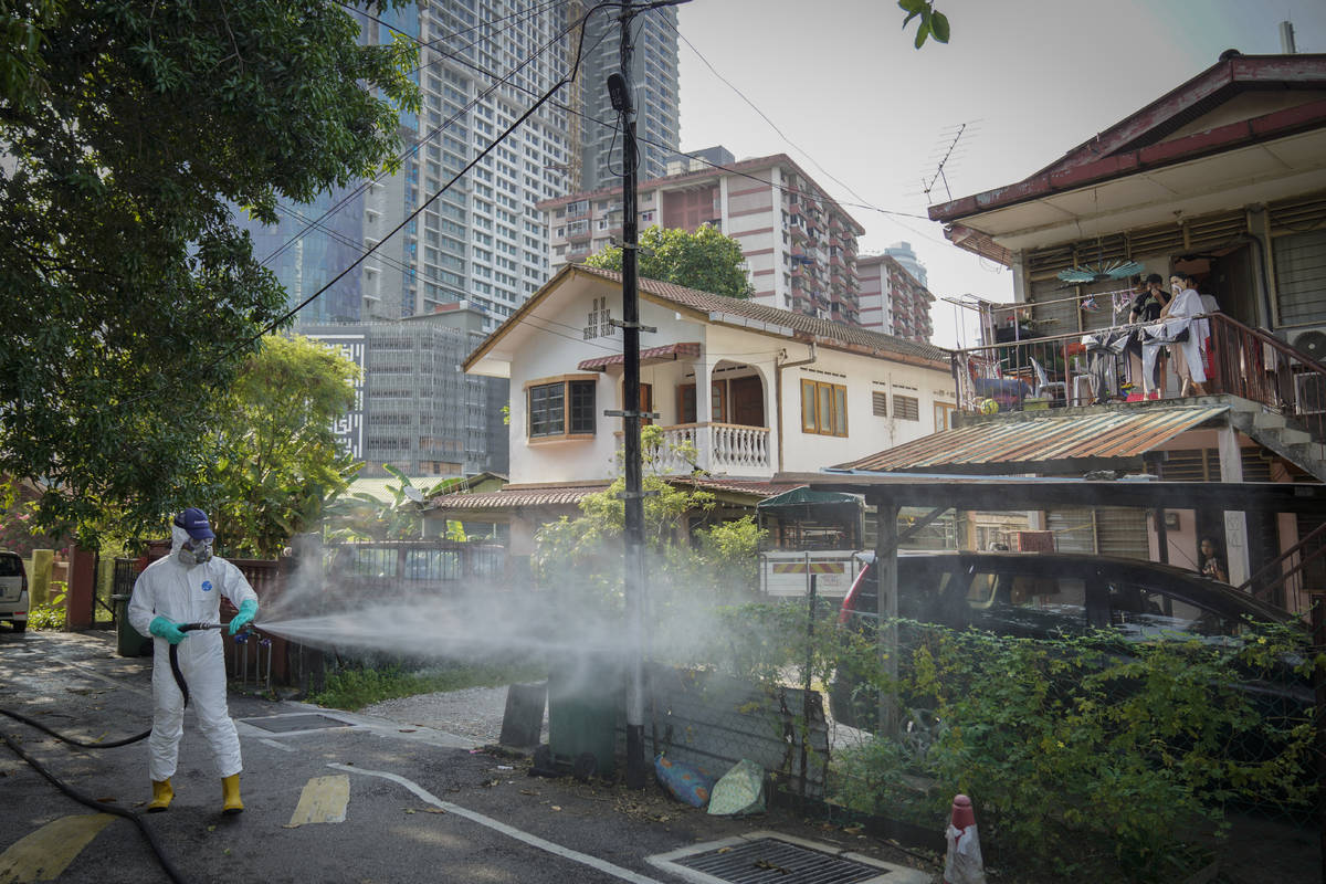 Health official spray disinfectant on Kampung Baru, a traditional Malay village in Kuala Lumpur ...