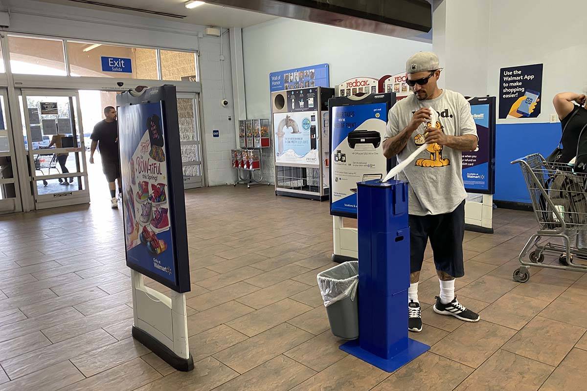 A customers grabs sanitizing wipes at Walmart Supercenter at 3950 W. Lake Mead Blvd. in North L ...