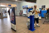 A customers grabs sanitizing wipes at Walmart Supercenter at 3950 W. Lake Mead Blvd. in North L ...