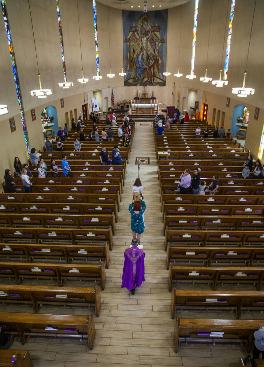 Monsignor Gordon, purple, begins Sunday Mass at St. Anne's Catholic Church where parishioners w ...
