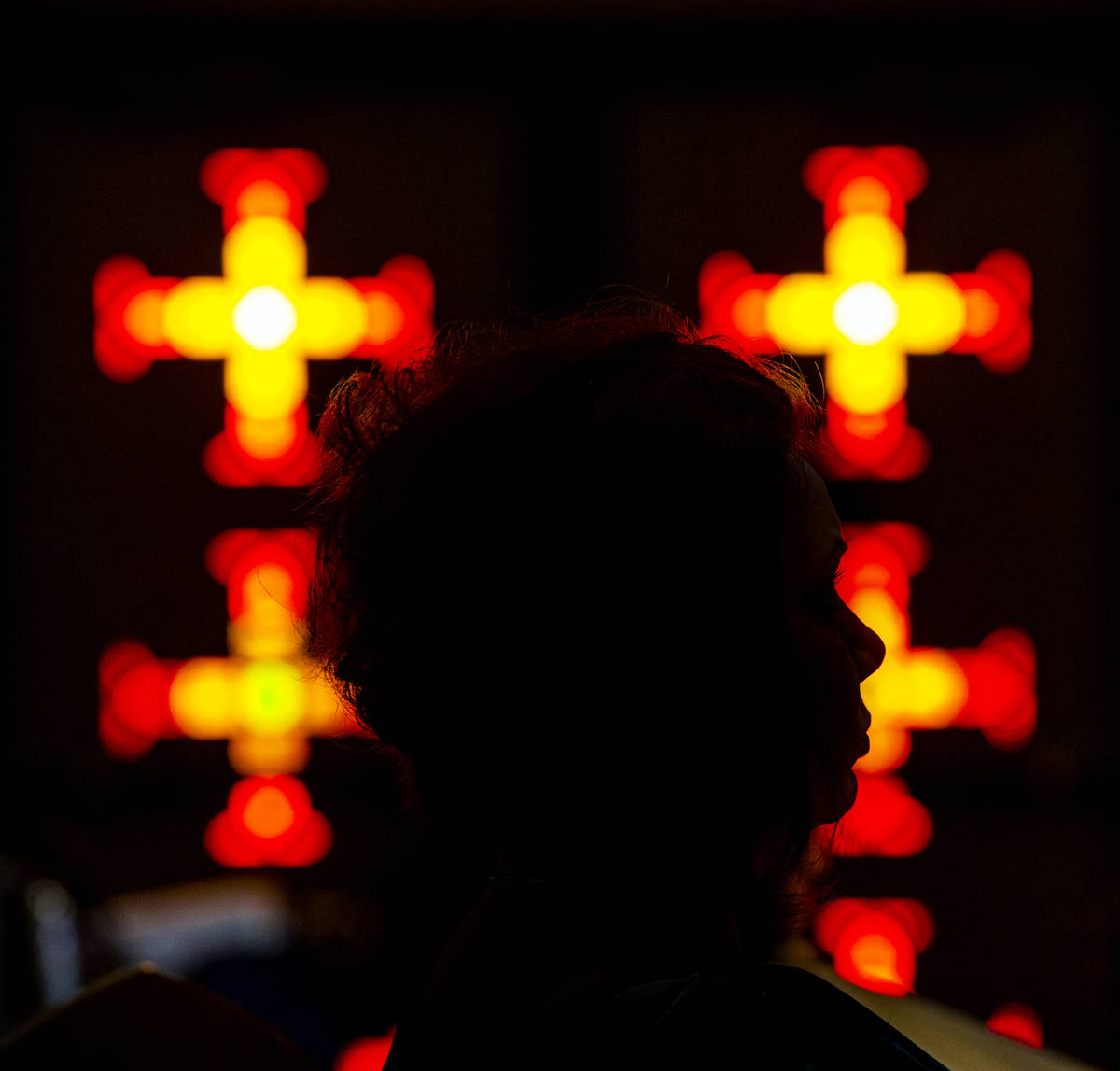 A parishioner prays during Sunday Mass at St. Anne's Catholic Church where they were asked to u ...