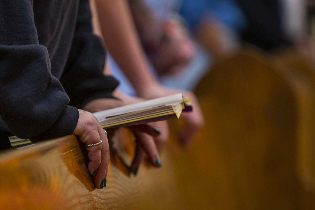 Parishioners pray during Sunday Mass at St. Anne's Catholic Church where they were asked to use ...